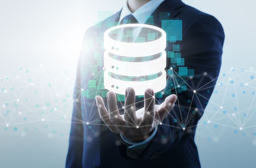Person holding an icon of a database